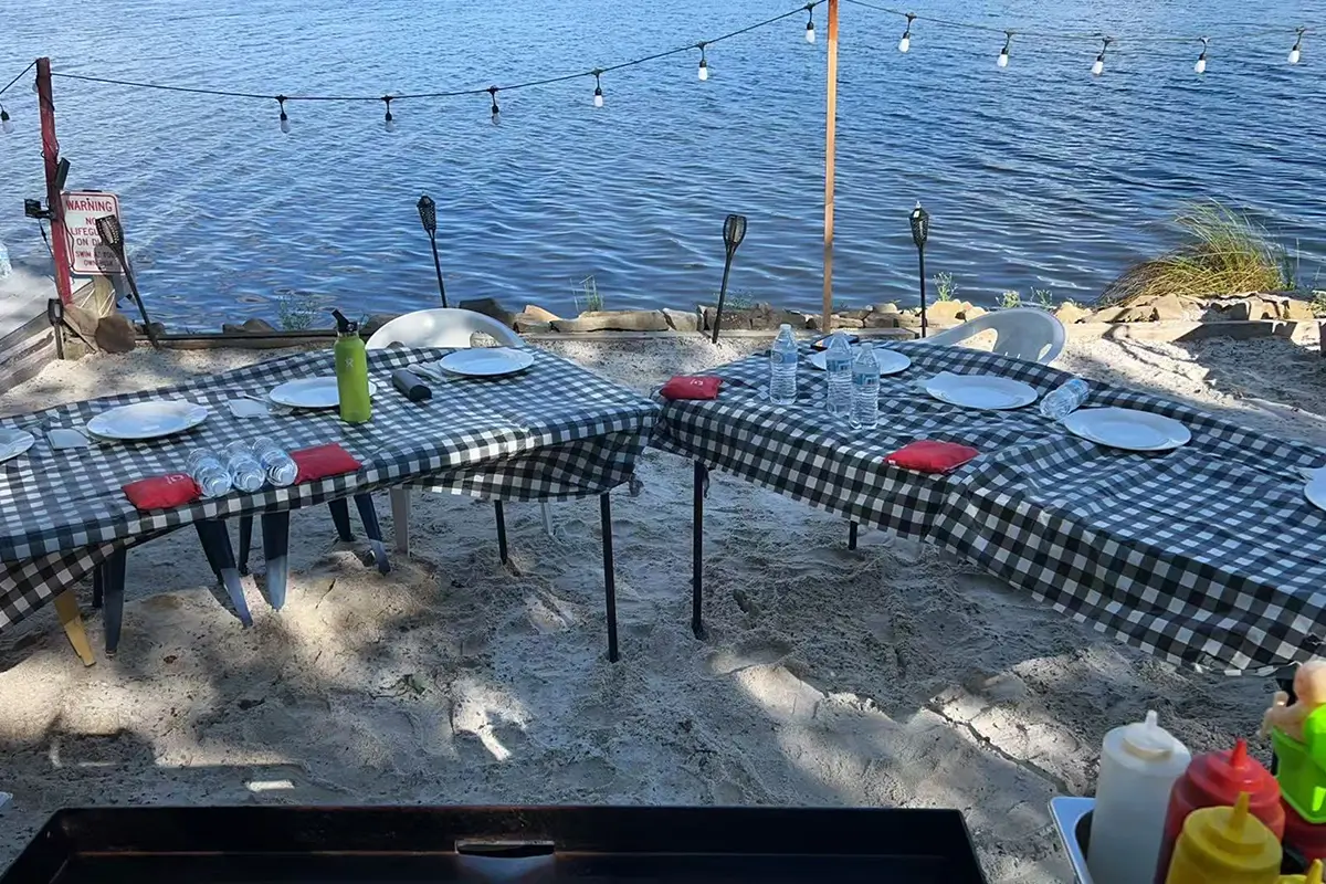 Seaside activity venue. The ground has a checkered pattern, with the sea and related facilities around