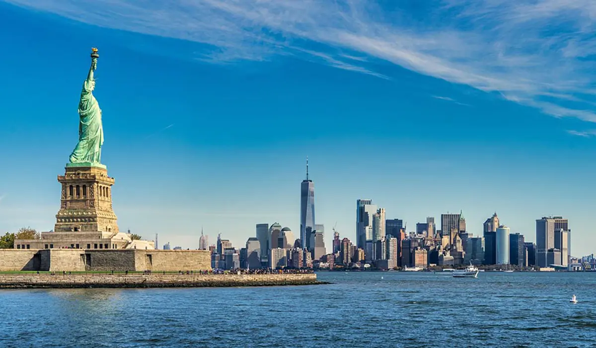 New York landscape image, featuring the Statue of Liberty and Manhattan skyline against blue water